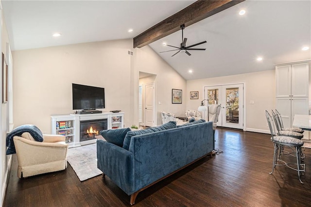 living room with french doors, dark wood finished floors, vaulted ceiling with beams, recessed lighting, and a glass covered fireplace