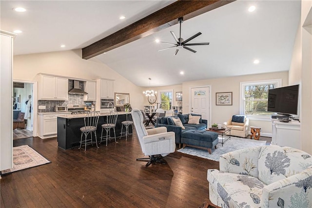 living room featuring vaulted ceiling with beams, dark wood-type flooring, ceiling fan with notable chandelier, and recessed lighting