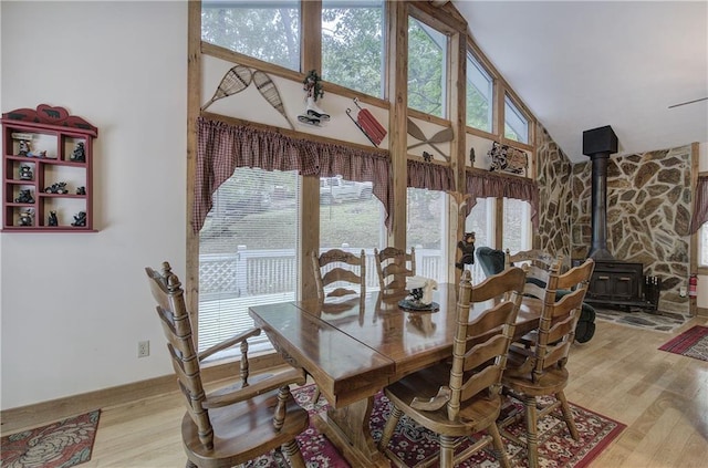 214 S View Trl, Jasper, GA 30143 - dining space with high vaulted ceiling, a wood stove, wood finished floors, and healthy amount of natural light