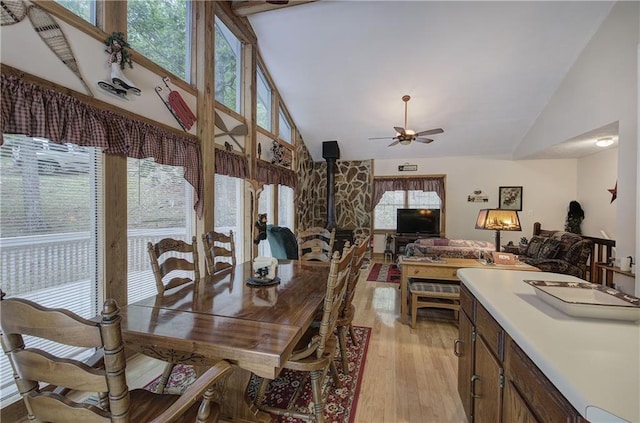 214 S View Trl, Jasper, GA 30143 - dining room featuring light wood-style flooring, a ceiling fan, high vaulted ceiling, a wood stove, and healthy amount of natural light