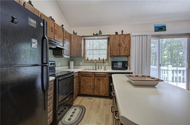 214 S View Trl, Jasper, GA 30143 - kitchen with black appliances, exhaust hood, light wood-style floors, light countertops, and brown cabinetry