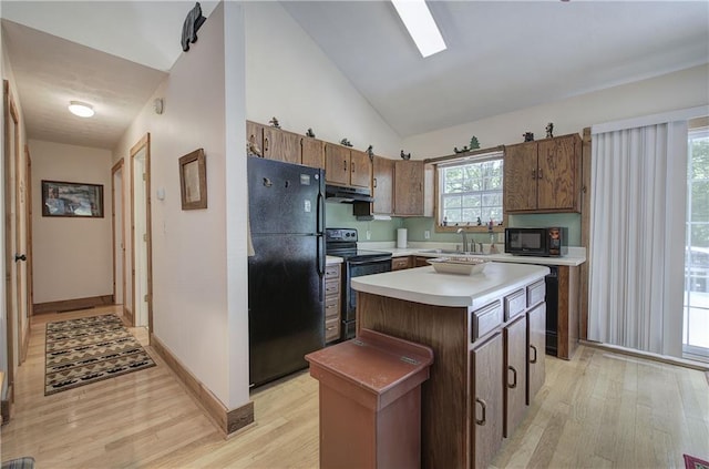 214 S View Trl, Jasper, GA 30143 - kitchen with black appliances, under cabinet range hood, light wood-style flooring, light countertops, and vaulted ceiling