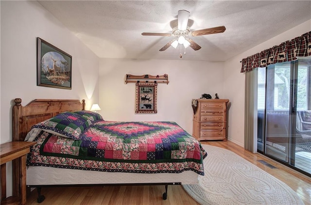 214 S View Trl, Jasper, GA 30143 - bedroom featuring access to exterior, wood finished floors, a textured ceiling, and a ceiling fan