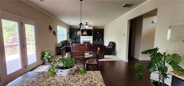 570 Eldridge Dr, Suwanee, GA 30024 - dining space featuring visible vents, crown molding, wood finished floors, a fireplace, and baseboards