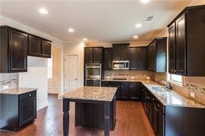 570 Eldridge Dr, Suwanee, GA 30024 - kitchen with decorative backsplash, dark wood-style flooring, a kitchen island, recessed lighting, and stainless steel appliances