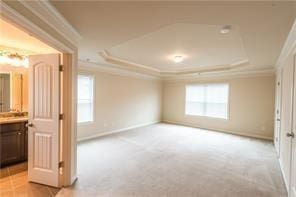 570 Eldridge Dr, Suwanee, GA 30024 - unfurnished room with crown molding, baseboards, light carpet, and a tray ceiling