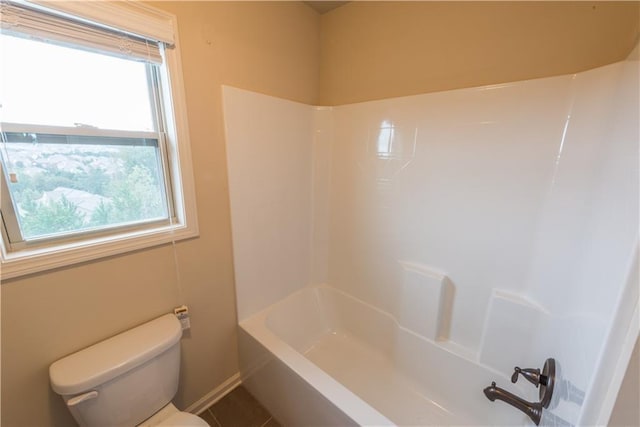 570 Eldridge Dr, Suwanee, GA 30024 - bathroom with baseboards, shower / bathtub combination, a healthy amount of sunlight, and toilet