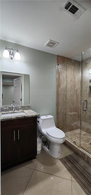 570 Eldridge Dr, Suwanee, GA 30024 - bathroom with vanity, a shower stall, toilet, and visible vents