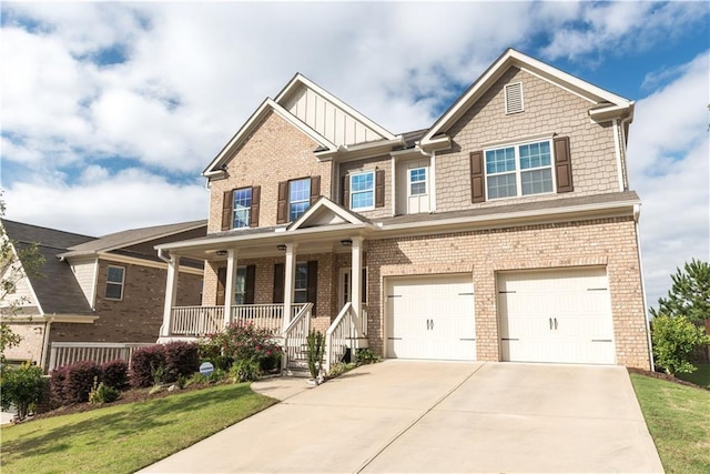 570 Eldridge Dr, Suwanee, GA 30024 - craftsman house with an attached garage, covered porch, brick siding, and concrete driveway