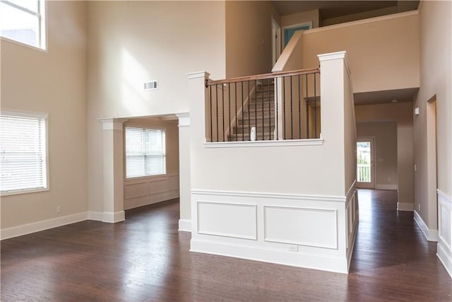 570 Eldridge Dr, Suwanee, GA 30024 - interior space featuring visible vents, baseboards, a towering ceiling, and wood finished floors