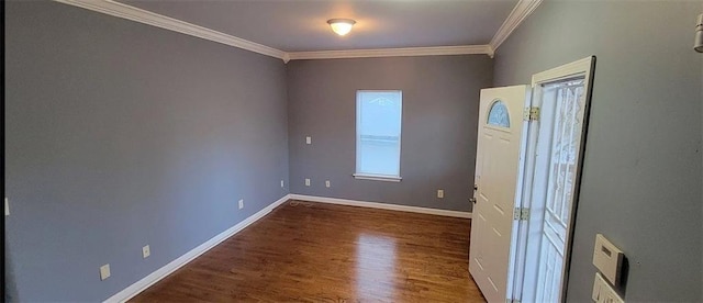 empty room featuring baseboards, dark wood finished floors, and crown molding