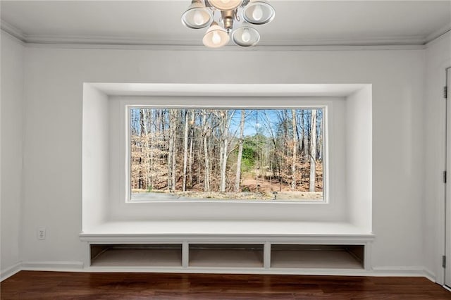 details with an inviting chandelier, crown molding, wood finished floors, and baseboards