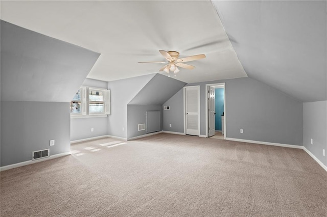 additional living space with visible vents, ceiling fan, baseboards, and carpet floors