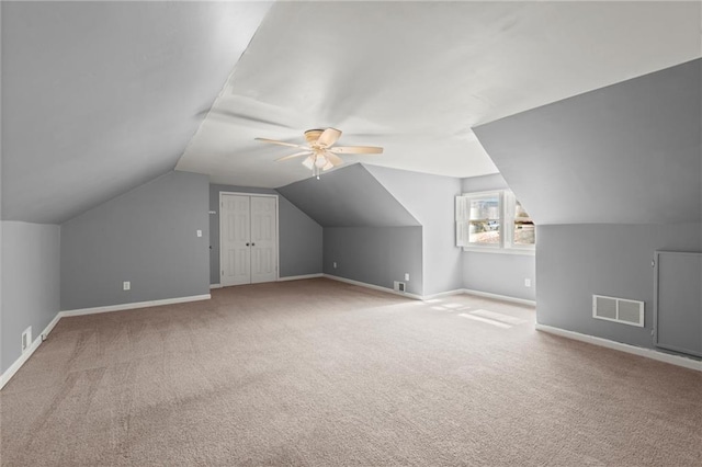 additional living space featuring carpet, visible vents, and baseboards