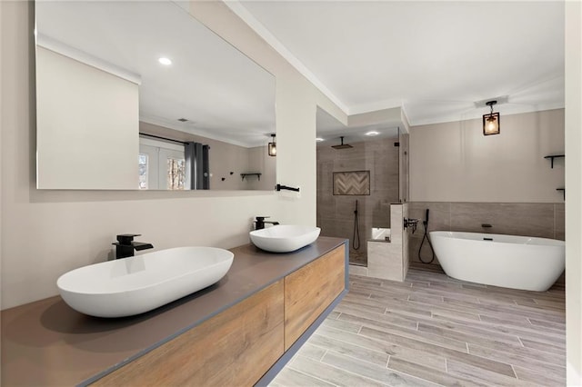 full bath featuring a sink, tiled shower, a freestanding bath, and wood tiled floor