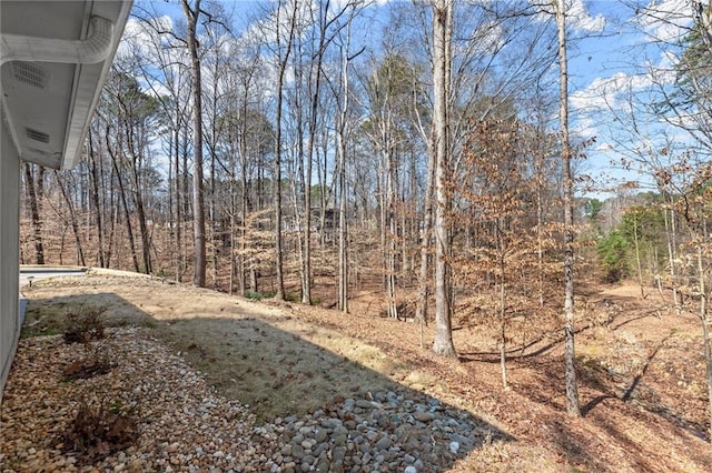 view of yard with a view of trees