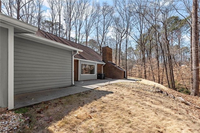 view of yard featuring central AC unit and a patio area