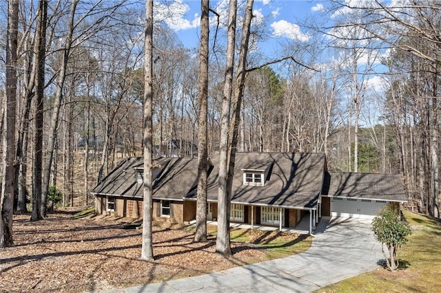 view of front of property with brick siding, an attached garage, and aphalt driveway