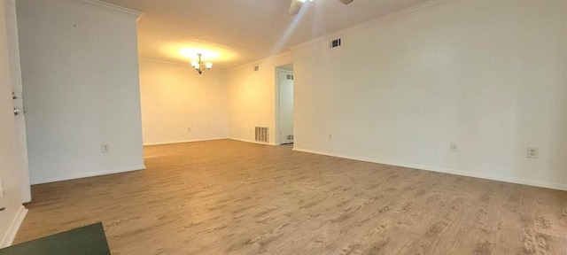 empty room featuring hardwood / wood-style flooring, ceiling fan, and ornamental molding