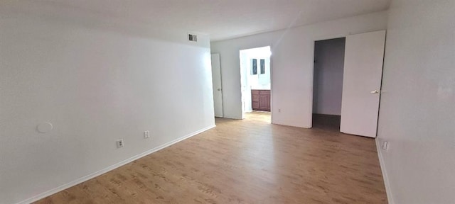 empty room with light hardwood / wood-style flooring