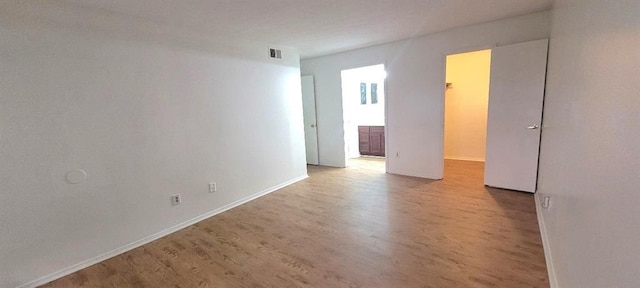 unfurnished room with light wood-type flooring