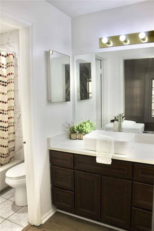 full bathroom with vanity, shower / bathtub combination with curtain, and toilet