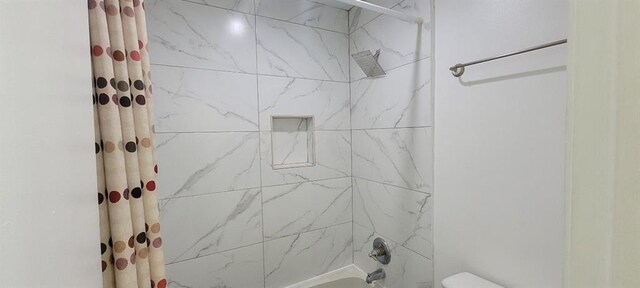 bathroom with toilet and shower / bathtub combination with curtain