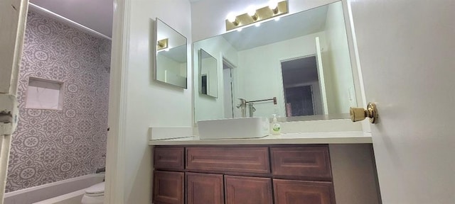 full bathroom featuring vanity, bathtub / shower combination, and toilet