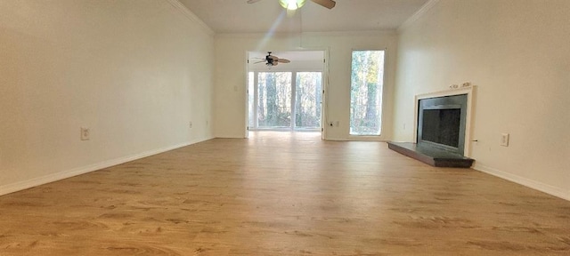 unfurnished living room with ceiling fan, ornamental molding, and light hardwood / wood-style flooring