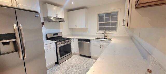 kitchen featuring white cabinetry, stainless steel appliances, and sink