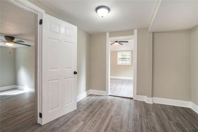 spare room featuring wood-type flooring and a textured ceiling