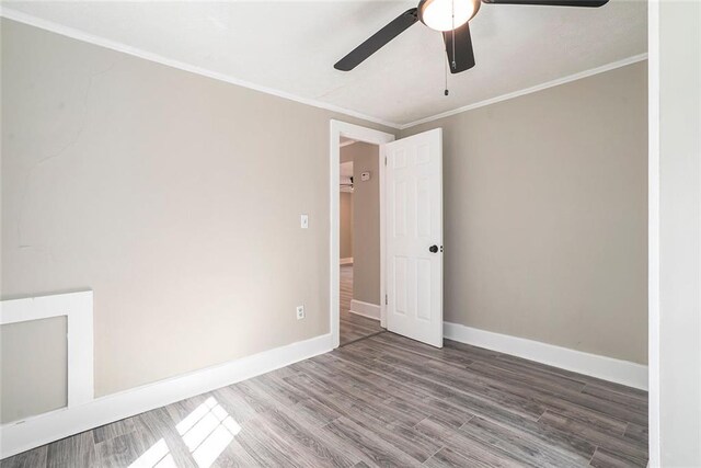 unfurnished room with ornamental molding, hardwood / wood-style flooring, and ceiling fan