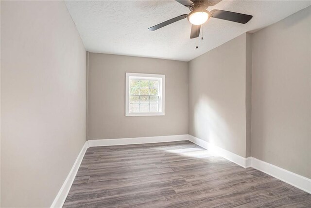 empty room featuring ceiling fan, a textured ceiling, and hardwood / wood-style floors