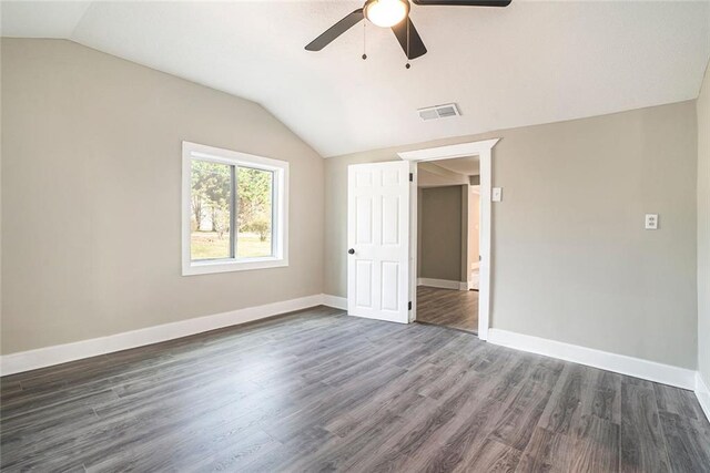 unfurnished room with lofted ceiling, dark hardwood / wood-style floors, and ceiling fan