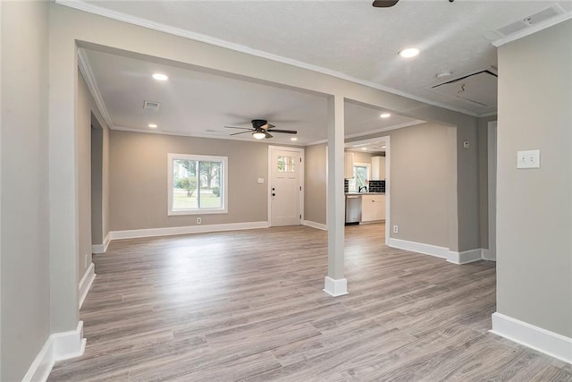 unfurnished living room featuring light hardwood / wood-style flooring, crown molding, and ceiling fan