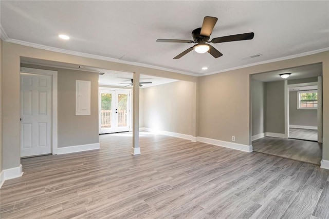 spare room with ornamental molding, light hardwood / wood-style flooring, and french doors