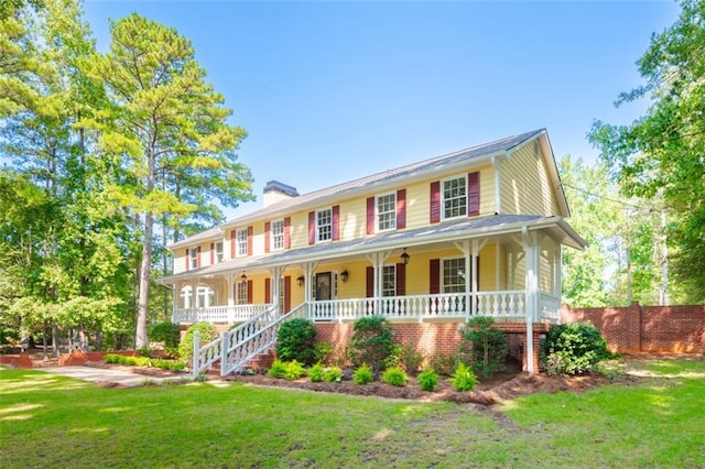 view of front of property with a front yard and covered porch