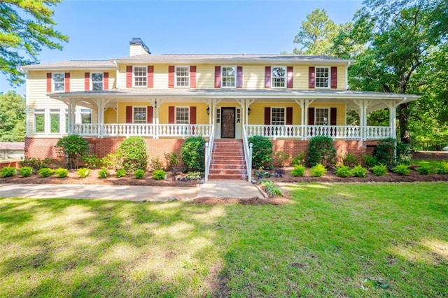 view of front of home with a porch and a front lawn