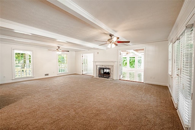 unfurnished living room with a textured ceiling, carpet, beam ceiling, and a high end fireplace