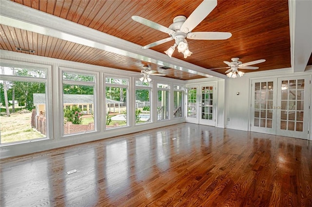 unfurnished sunroom with wooden ceiling, ceiling fan, plenty of natural light, and french doors