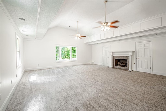 unfurnished living room featuring ceiling fan, a high end fireplace, a textured ceiling, light carpet, and vaulted ceiling