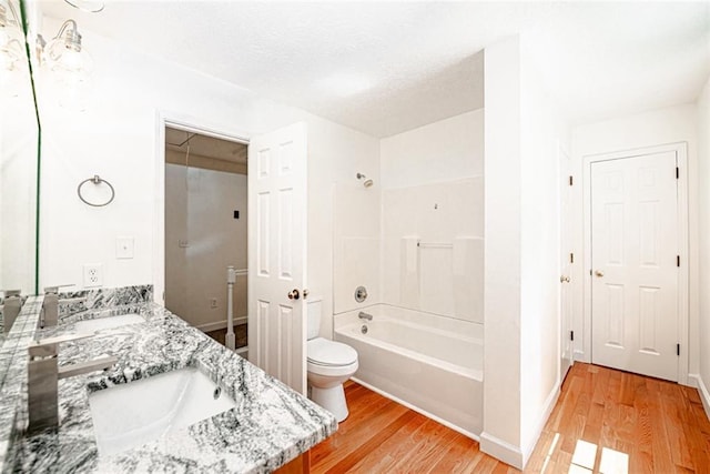 full bathroom featuring shower / bathing tub combination, hardwood / wood-style flooring, vanity, and toilet