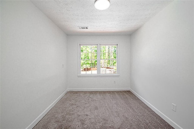 unfurnished room featuring carpet floors and a textured ceiling