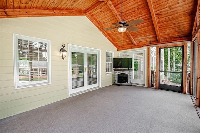 unfurnished sunroom with a wealth of natural light, lofted ceiling with beams, and wooden ceiling