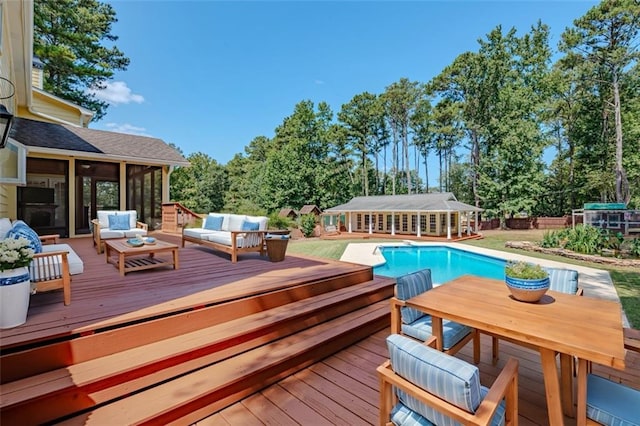 view of swimming pool featuring an outdoor living space, a wooden deck, and a sunroom