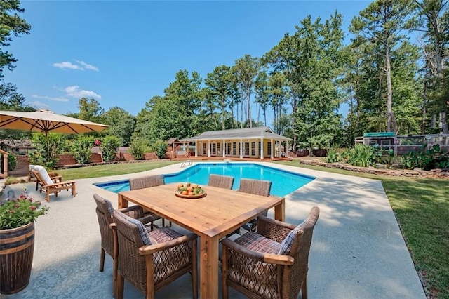 view of pool with a lawn and a patio area