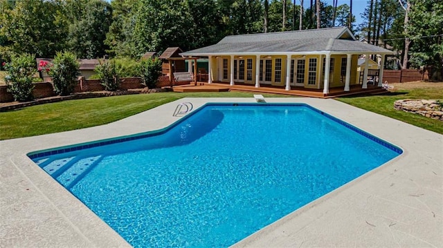 rear view of property with a lawn and a patio