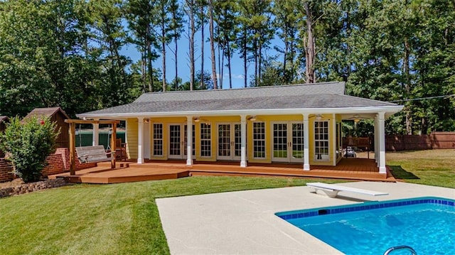 back of property with french doors, a yard, a patio area, and a swimming pool side deck