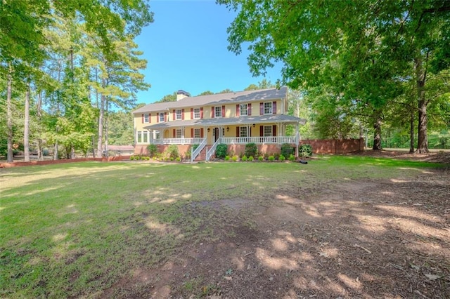 rear view of property with a yard