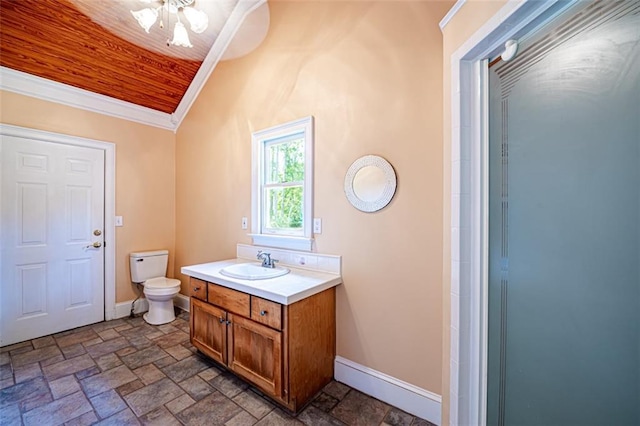 bathroom featuring ornamental molding, vaulted ceiling, vanity, and toilet